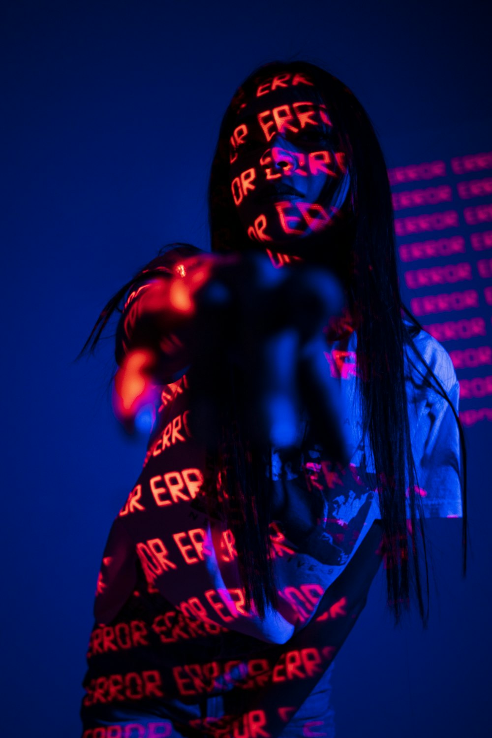 a woman's head is illuminated in red and blue light