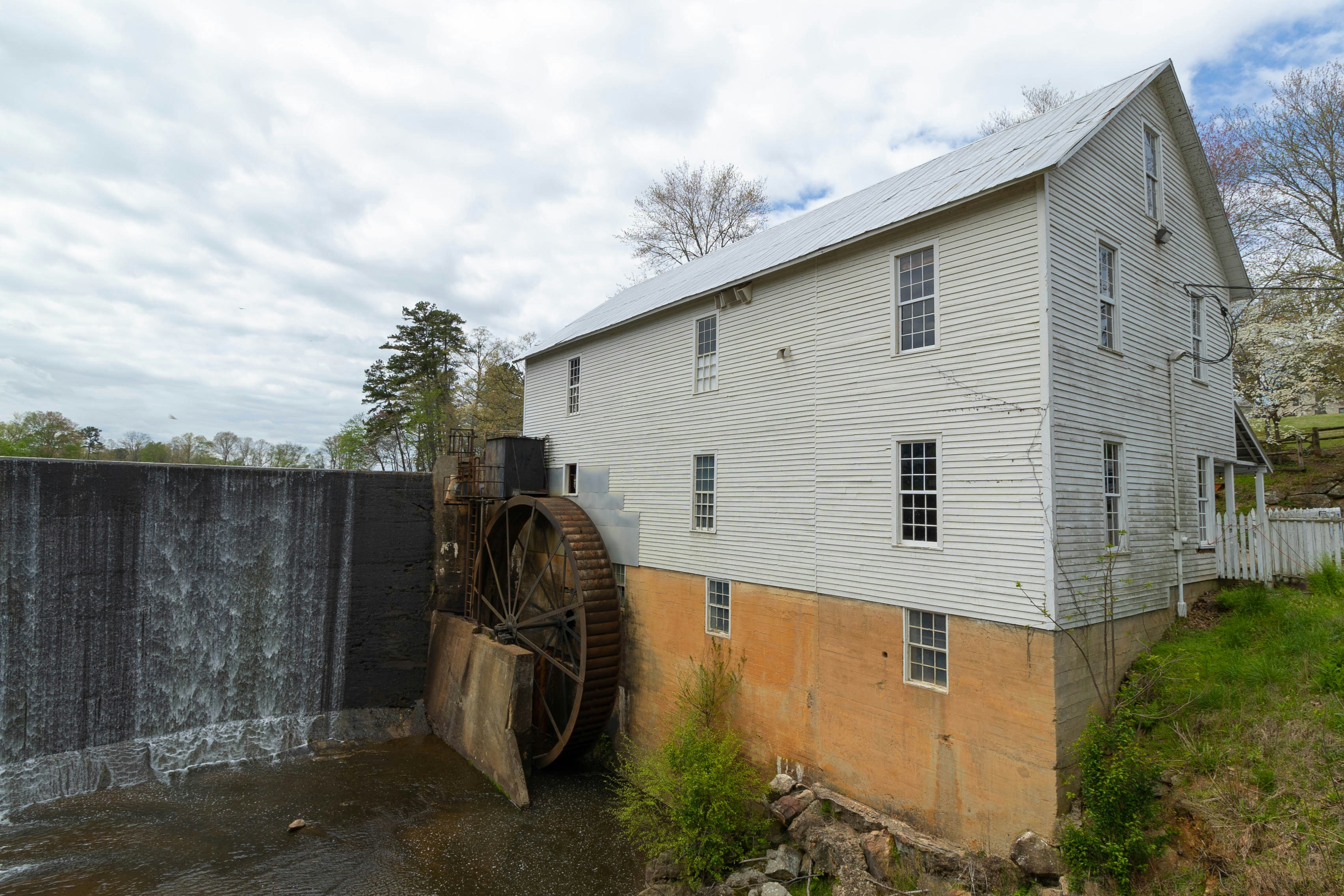 an old water wheel next to a building