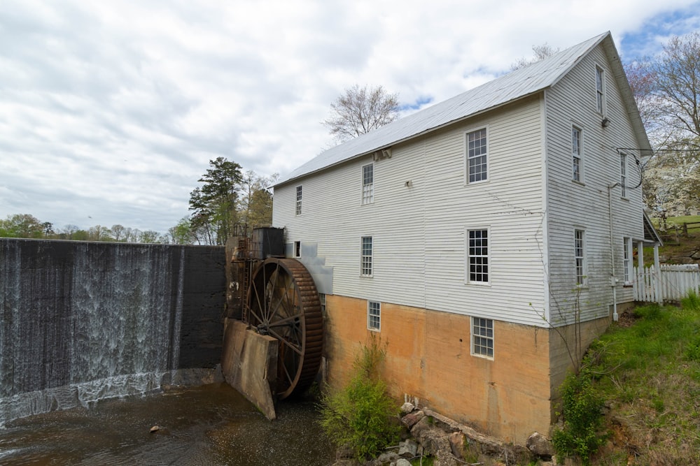 an old water wheel next to a building