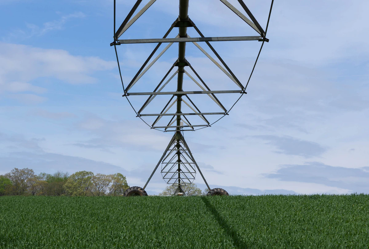 Close view of a center-pivot irrigation system over green crops