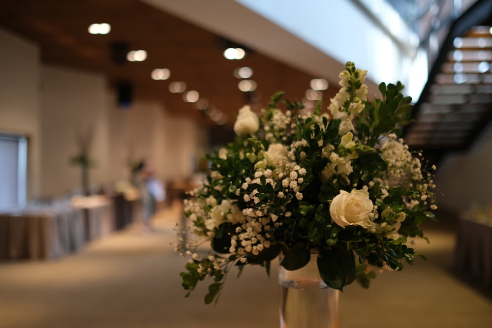 a vase filled with white flowers on top of a table