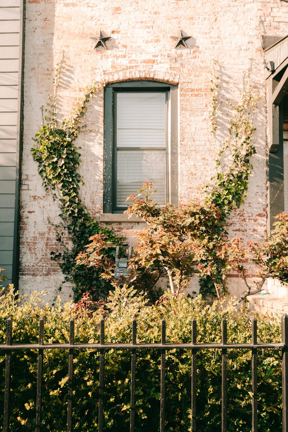 a brick building with a black iron fence in front of it