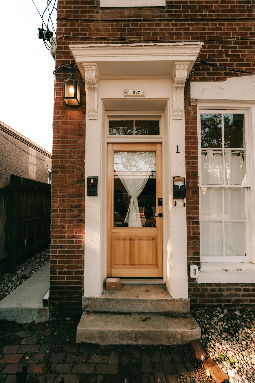 a brick building with a wooden door and window