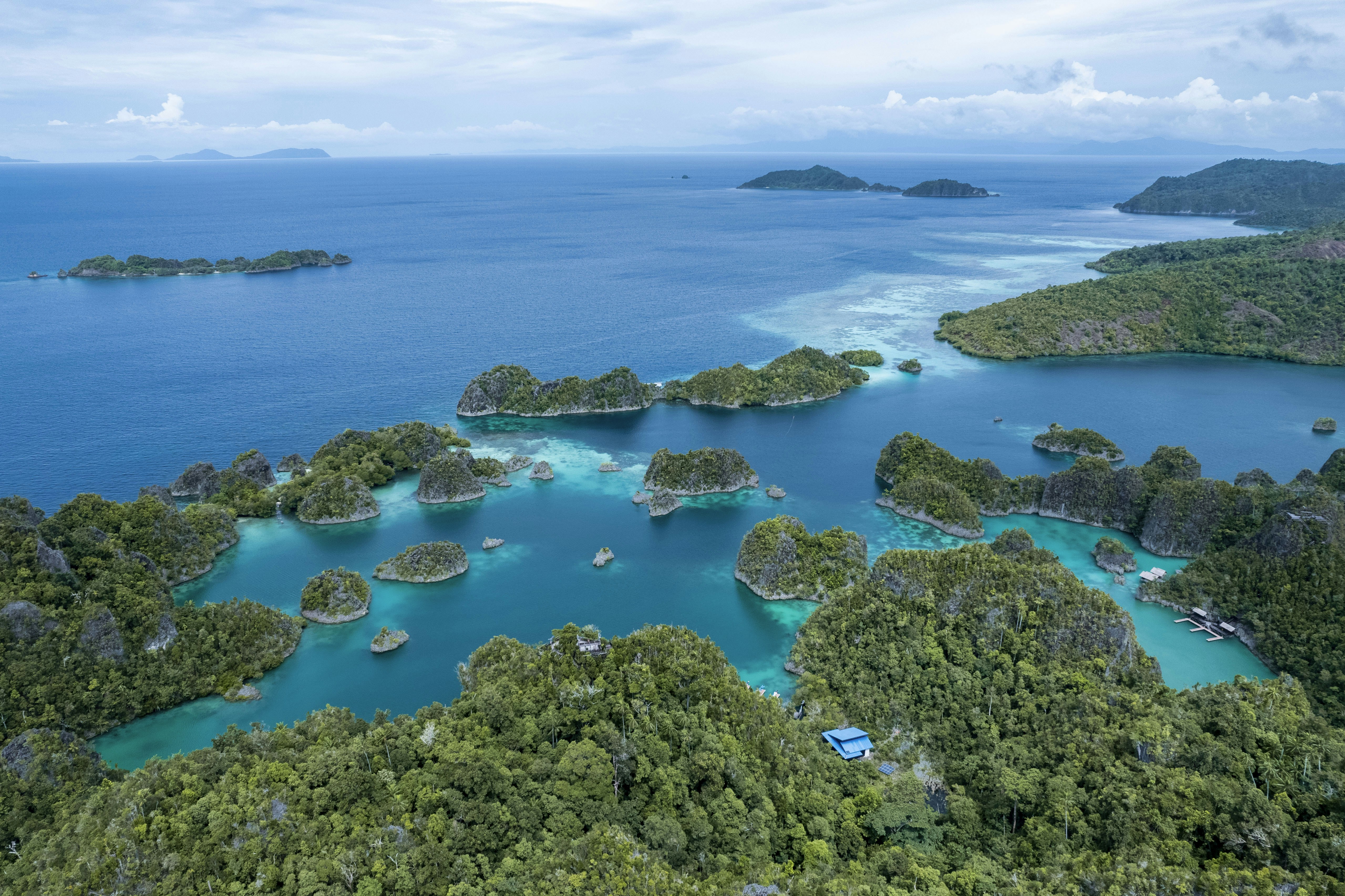 Aerial view to Pyanemo island and viewpoint (in the middle) at Raja Ampat, West Papua. On right top there is Rufas island, and further away Kri and Mansuar islands.