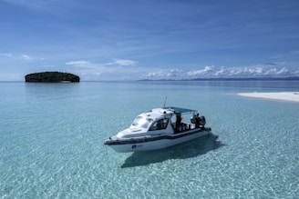 a small boat floating on top of a body of water