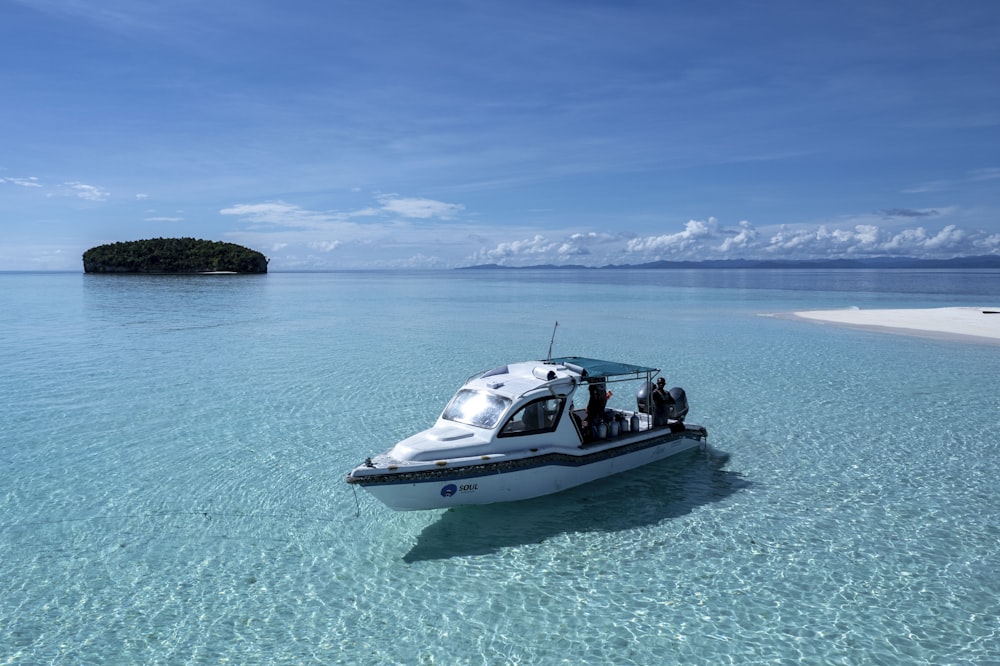 a small boat floating on top of a body of water