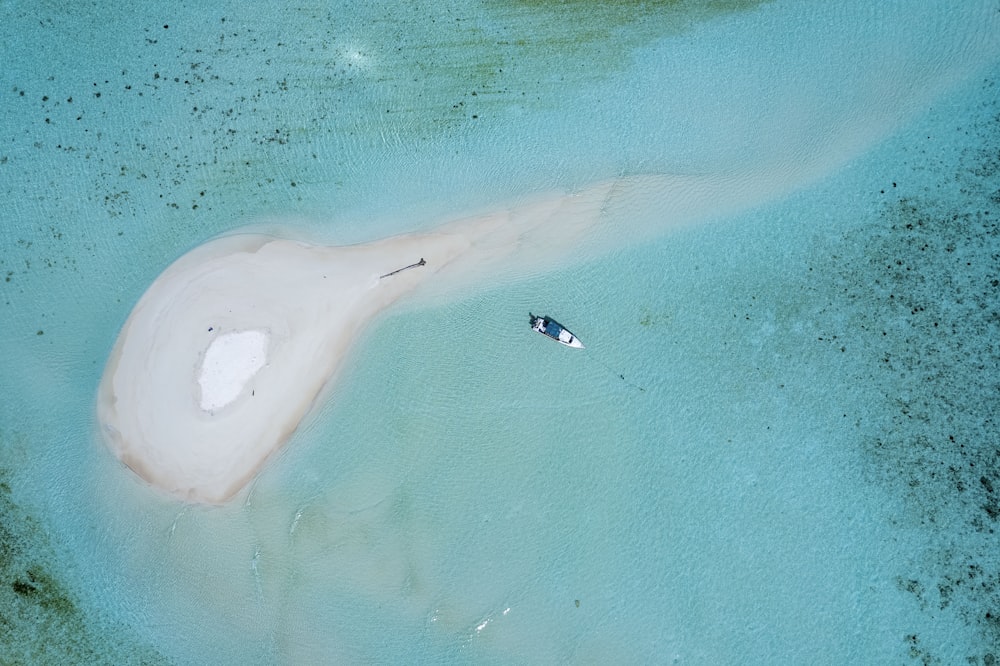 an aerial view of a boat in the water