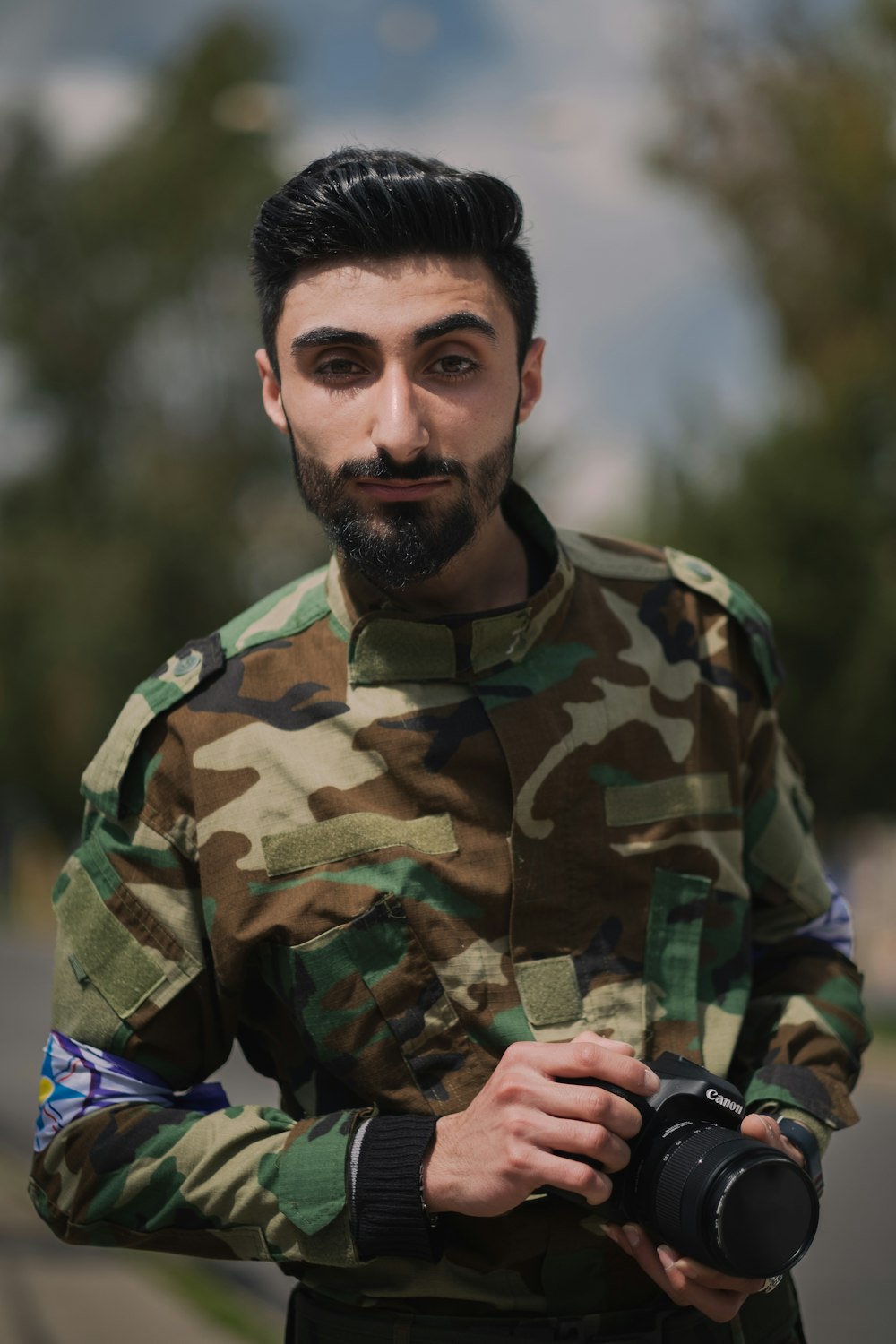 a man in a military uniform holding a camera