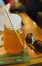 a mason jar filled with liquid and a straw