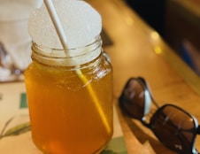 a mason jar filled with liquid and a straw