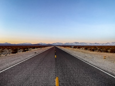 an empty road in the middle of the desert
