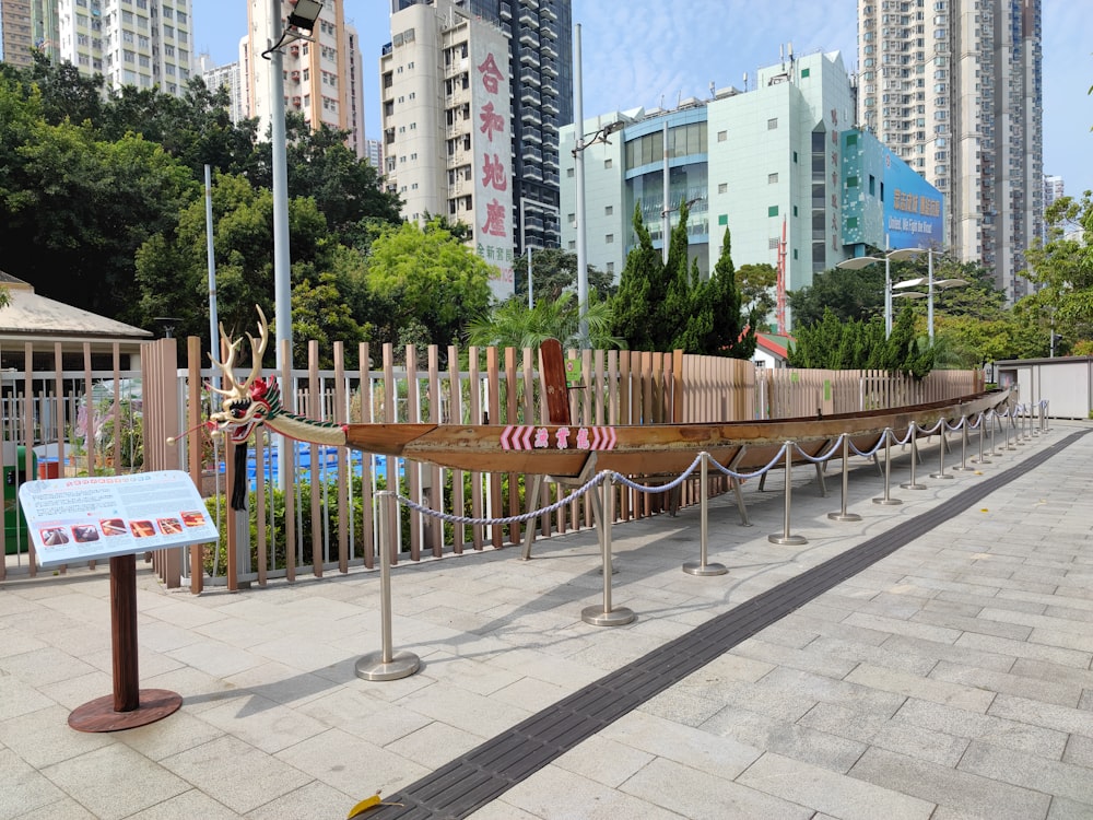 a wooden boat on display in a park