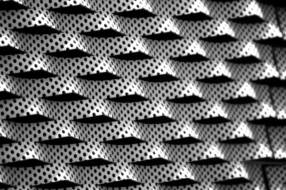 a black and white photo of a wall with dots