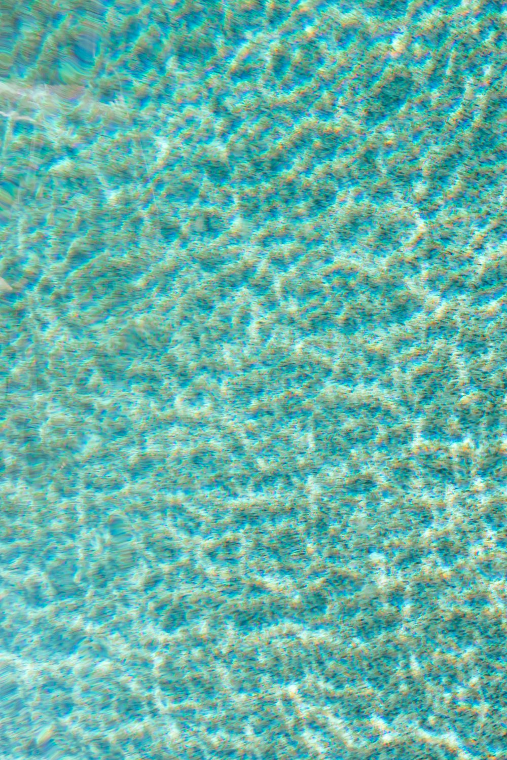 a close up view of a pool with blue water