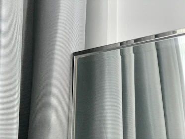 Shiny steel pipes aligned horizontally, reflecting the clean industrial environment.