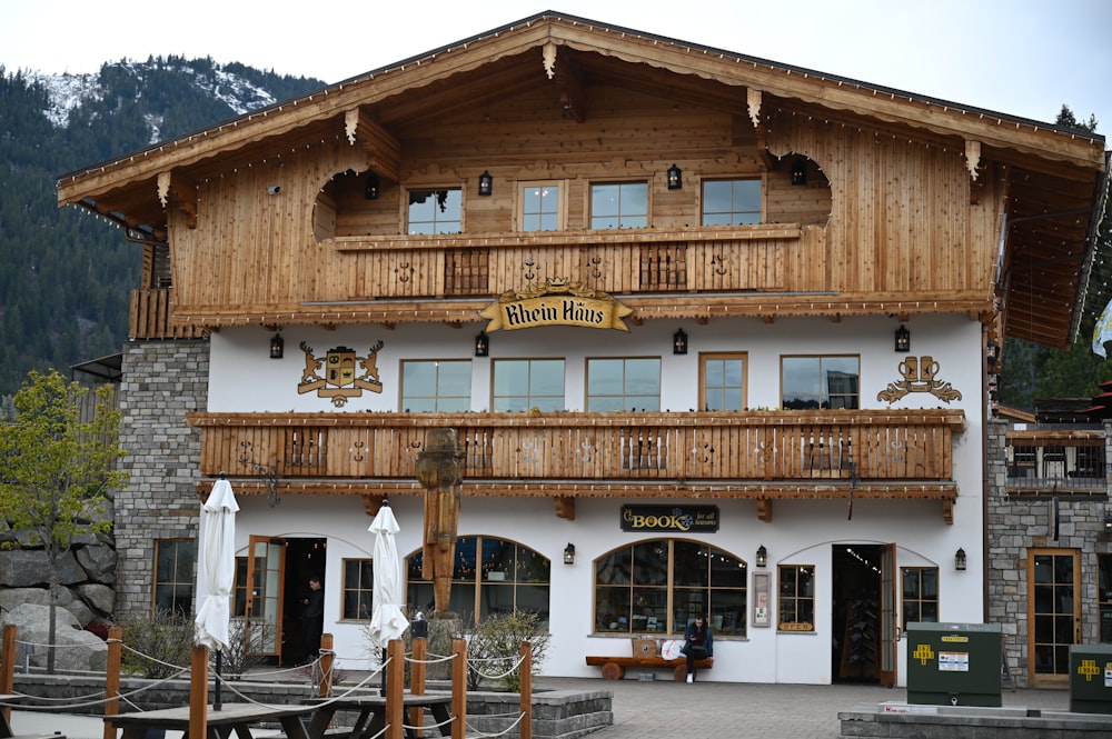 a large white building with a wooden balcony