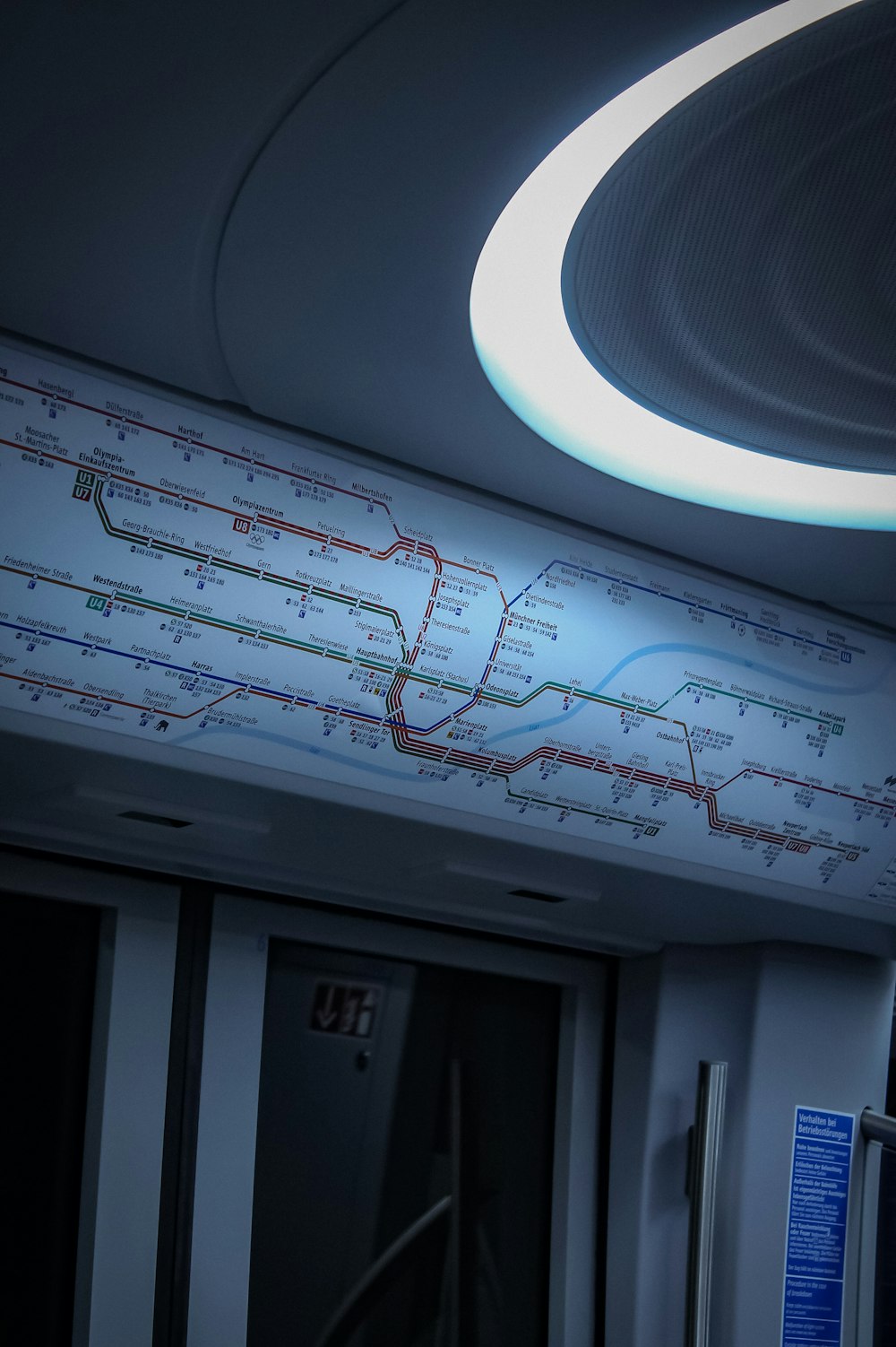 a subway train with a circular light above it