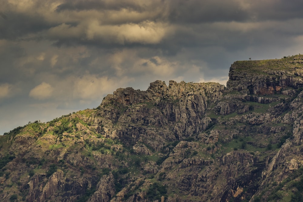 a very tall mountain with a very cloudy sky