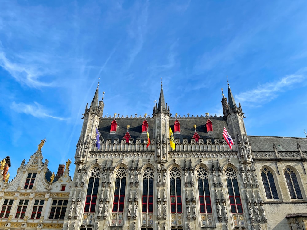 a large building with a lot of windows and flags on it