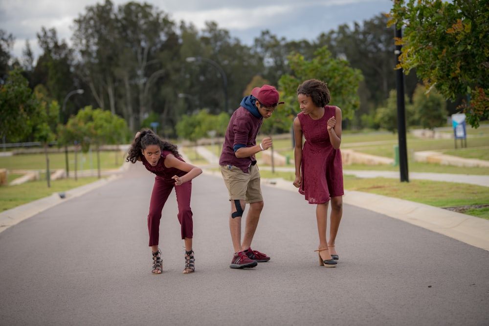 a group of people standing on the side of a road