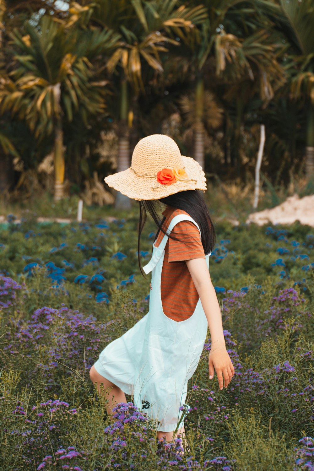 a little girl in a field of purple flowers