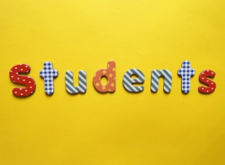 a yellow background with the word students spelled out