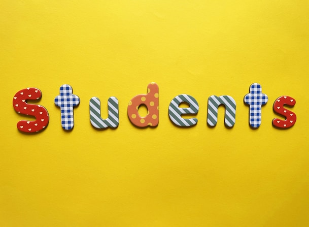 a yellow background with the word students spelled out