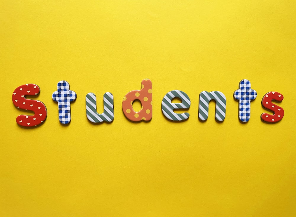 a yellow background with the word students spelled out