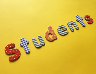 a yellow background with the words students spelled out