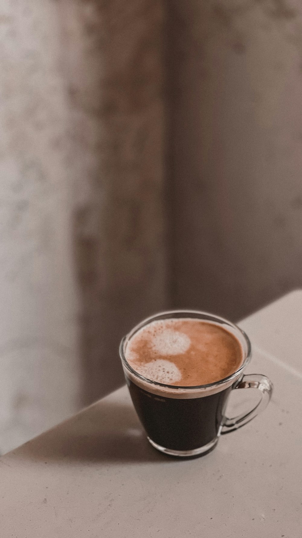 a cup of coffee sitting on top of a table