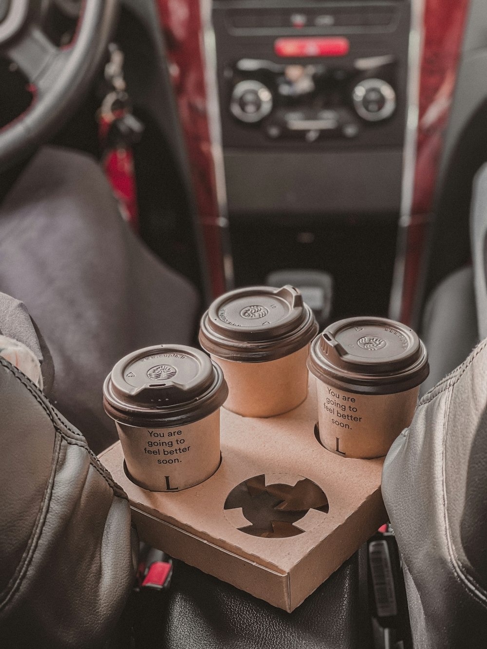 three cups of coffee sitting on top of a cardboard box