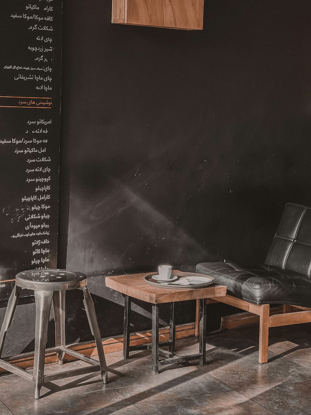 a room with a black wall and a wooden table