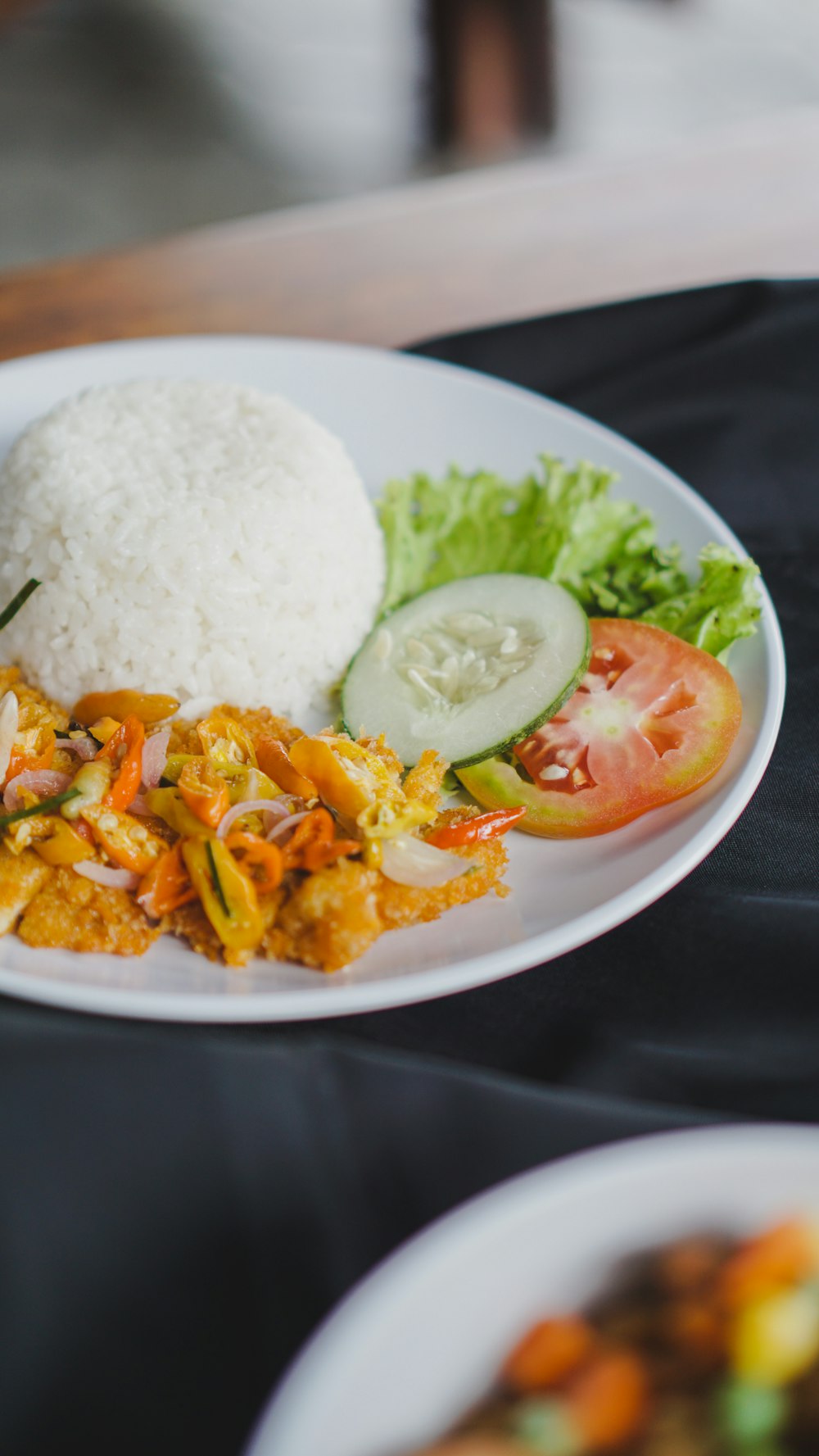 a white plate topped with rice and veggies