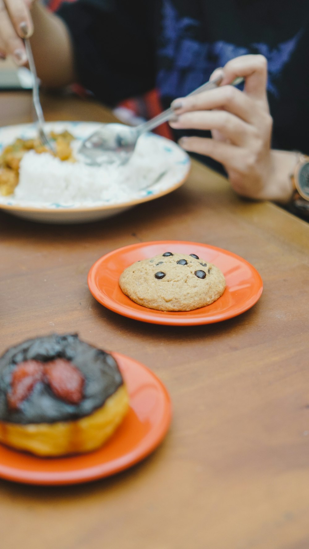 a table topped with plates of donuts covered in frosting