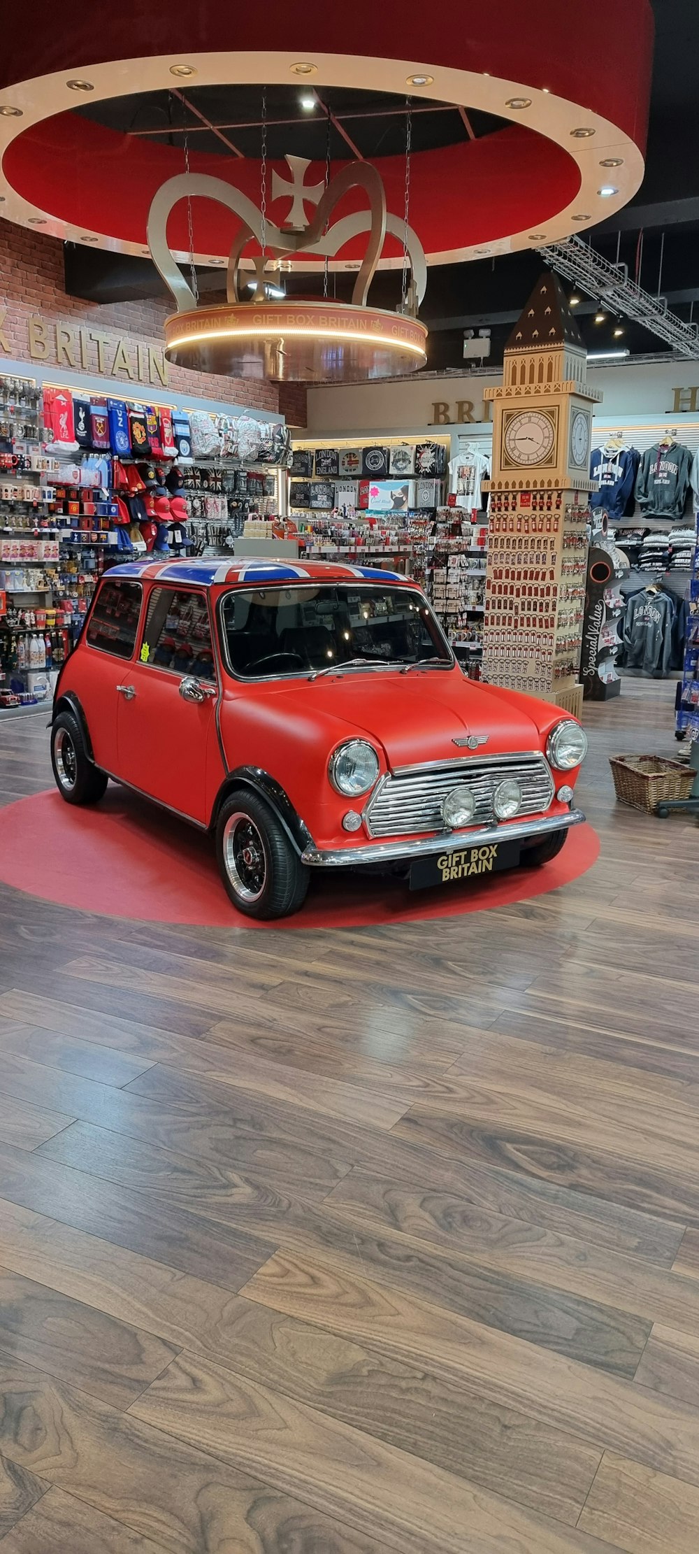 a small red car is on display in a store
