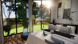 Modern bedroom inside garden suite with large windows showing lush foliage