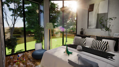 Modern bedroom inside garden suite with large windows showing lush foliage