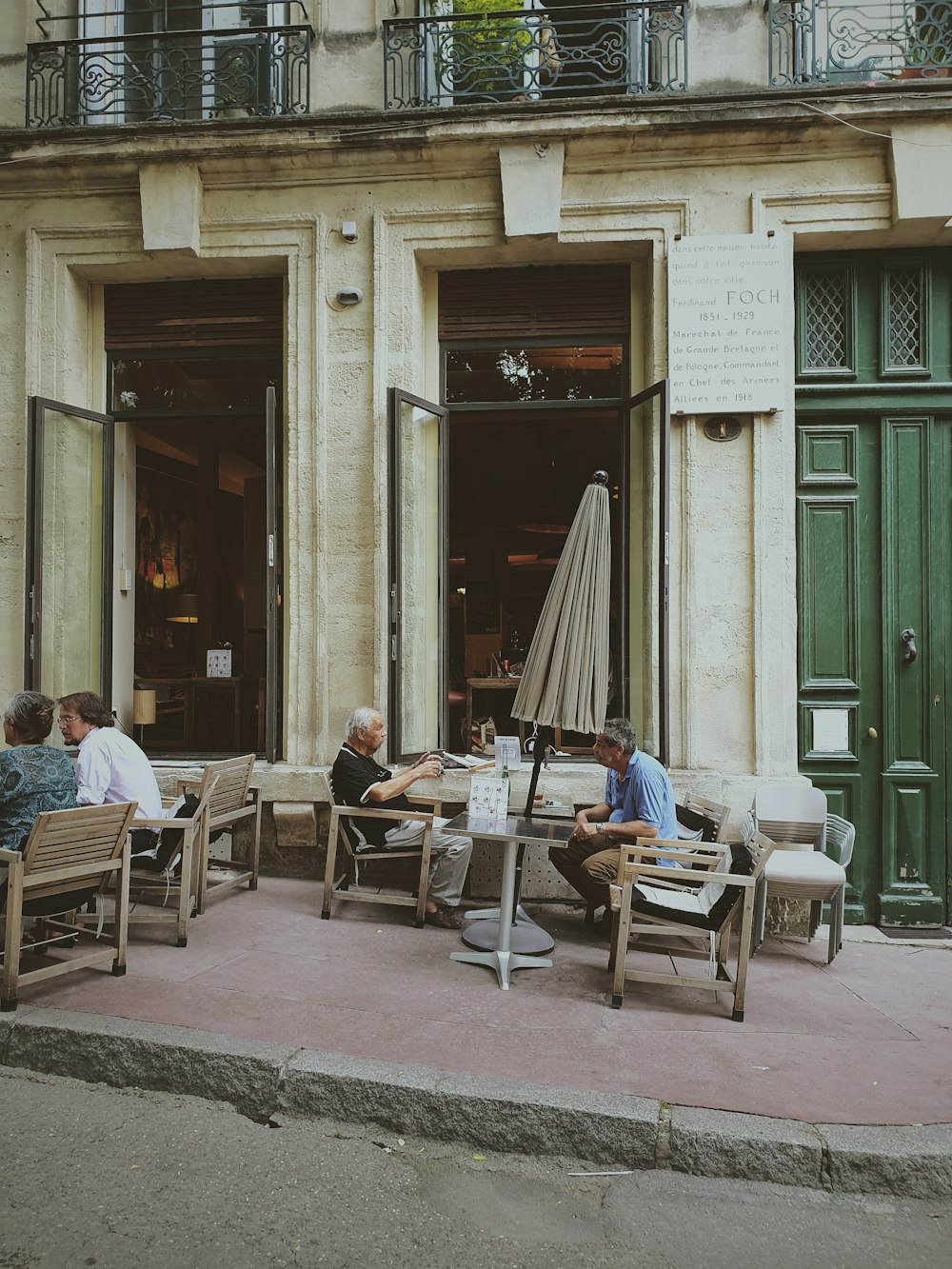 a group of people sitting outside of a building