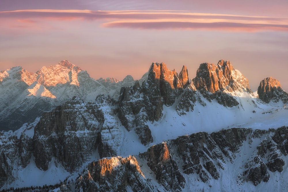 a mountain range with snow covered mountains in the background