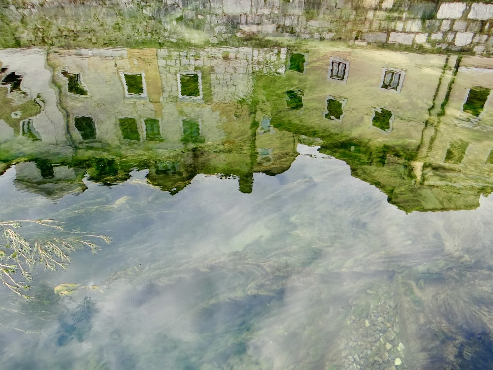 a reflection of a building in a body of water