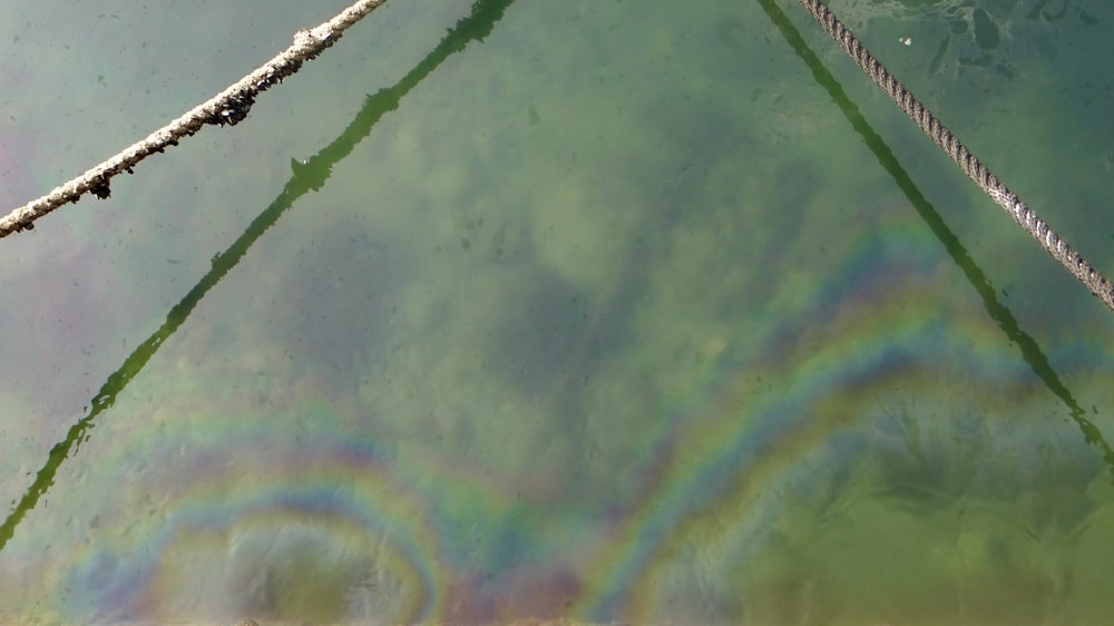 a view of a body of water with a rainbow in the water