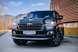 a black toyota land cruiser parked in front of a building