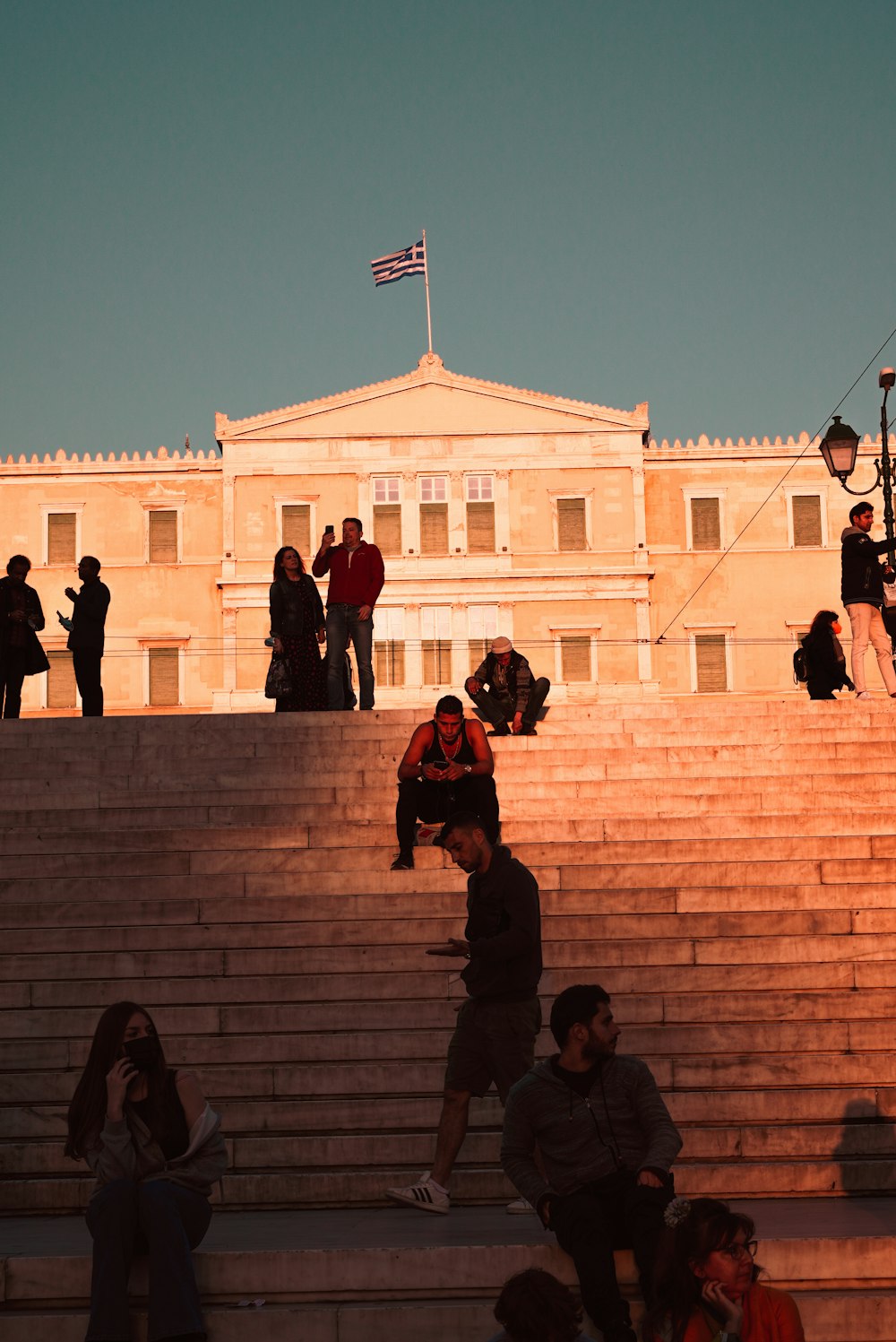 a group of people sitting on steps in front of a building