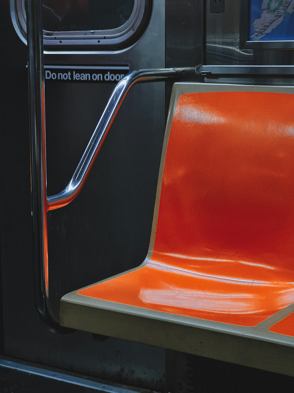 a close up of an orange seat on a train