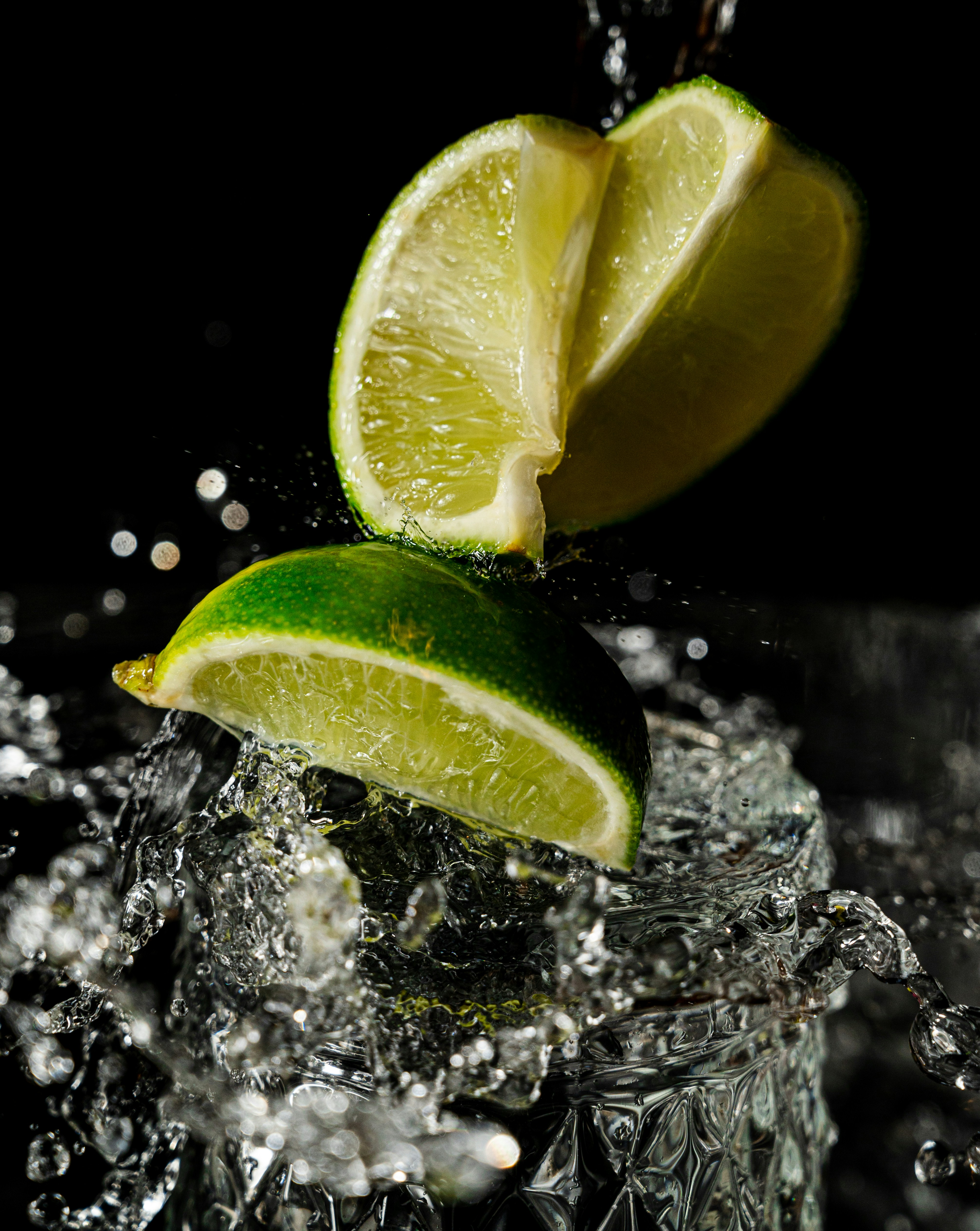 a lime wedged into a glass of water