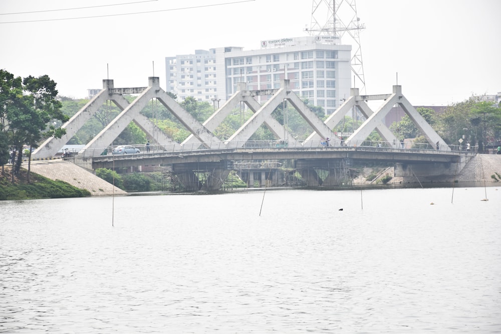 a bridge over a body of water with buildings in the background