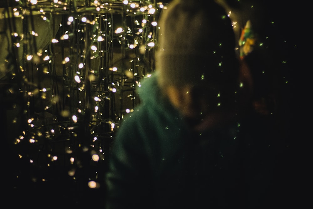 a woman standing in front of a christmas tree