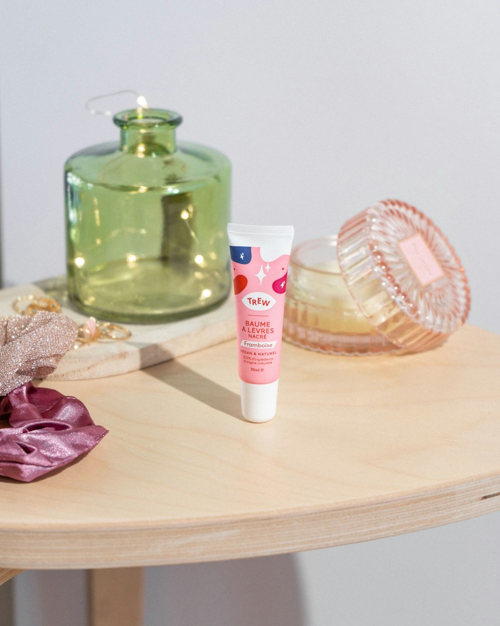 a wooden table topped with a bottle of lotion