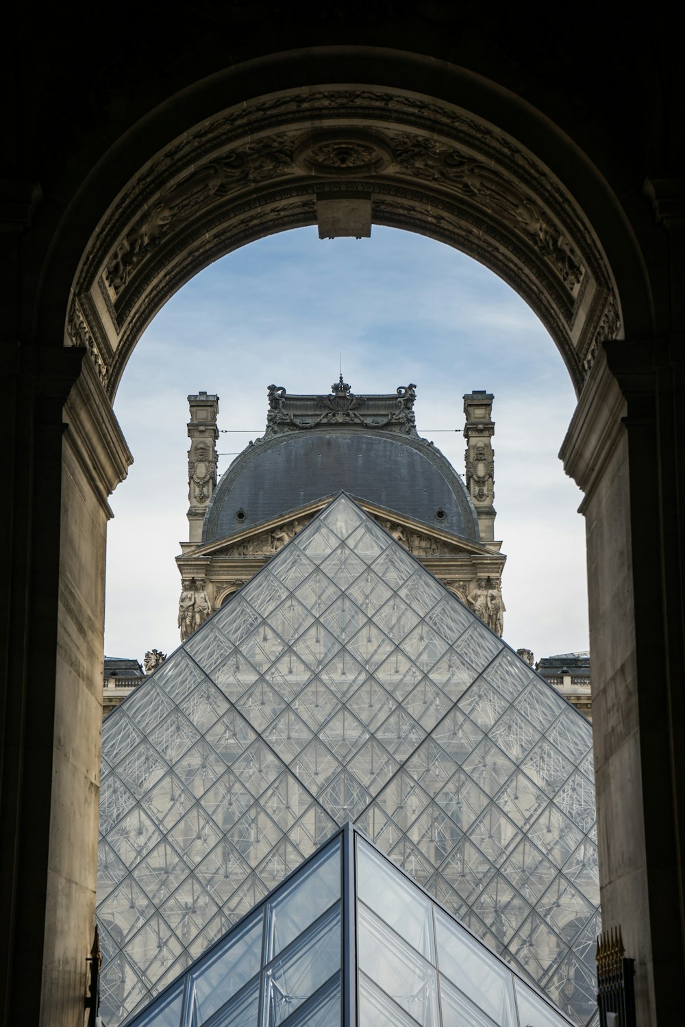 a very tall building with a very tall pyramid in front of it