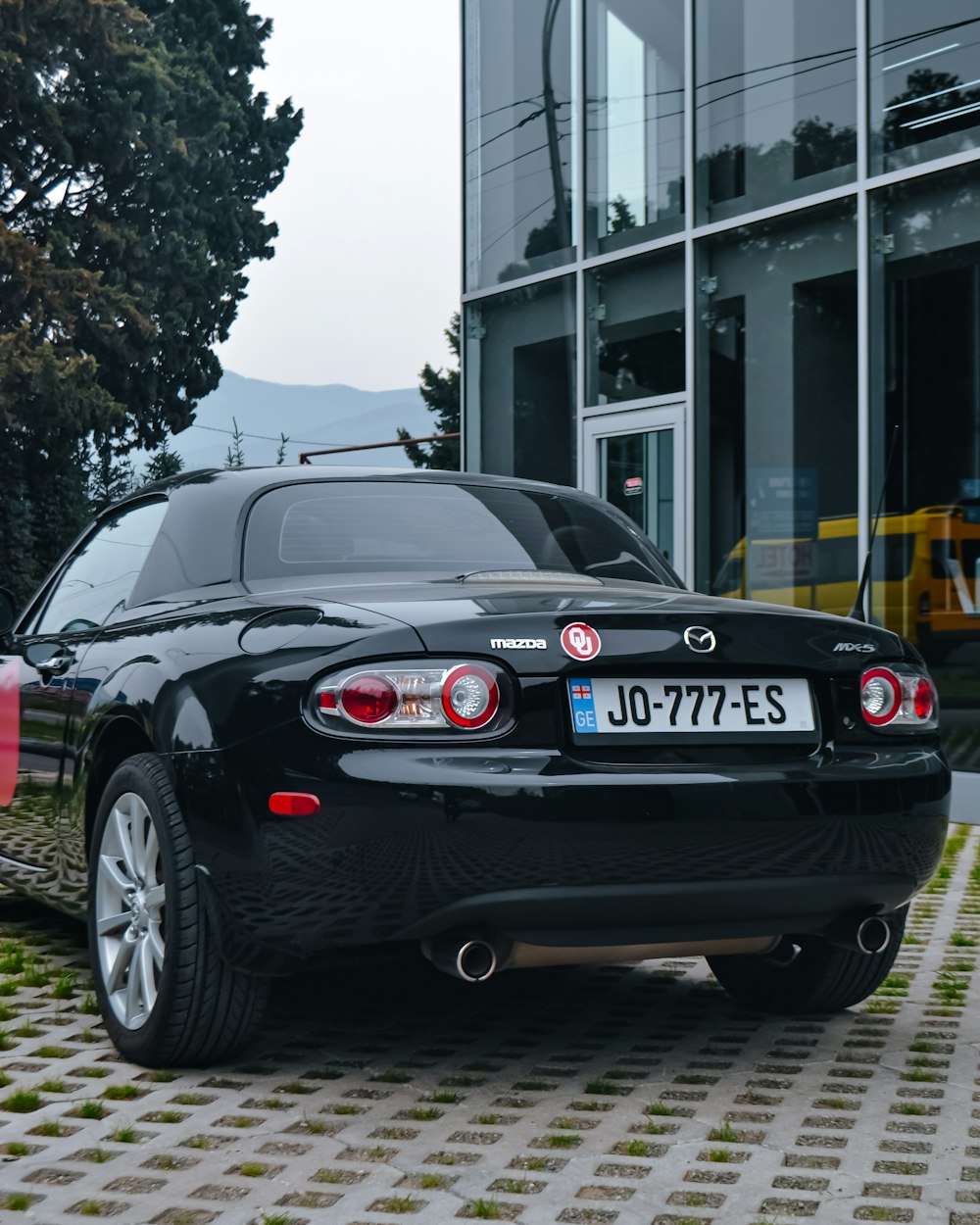 a black sports car parked in front of a building